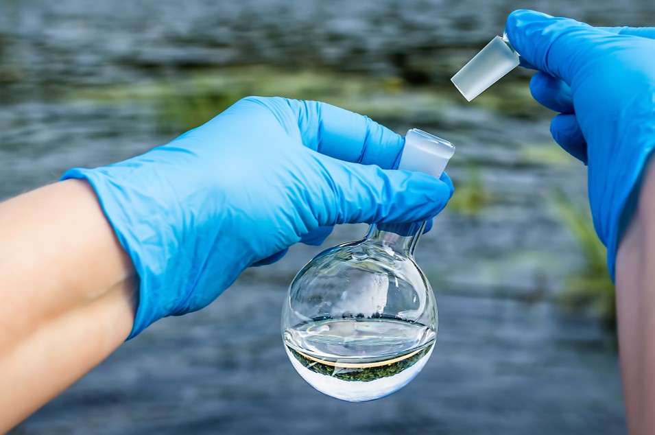 taking water sample from river